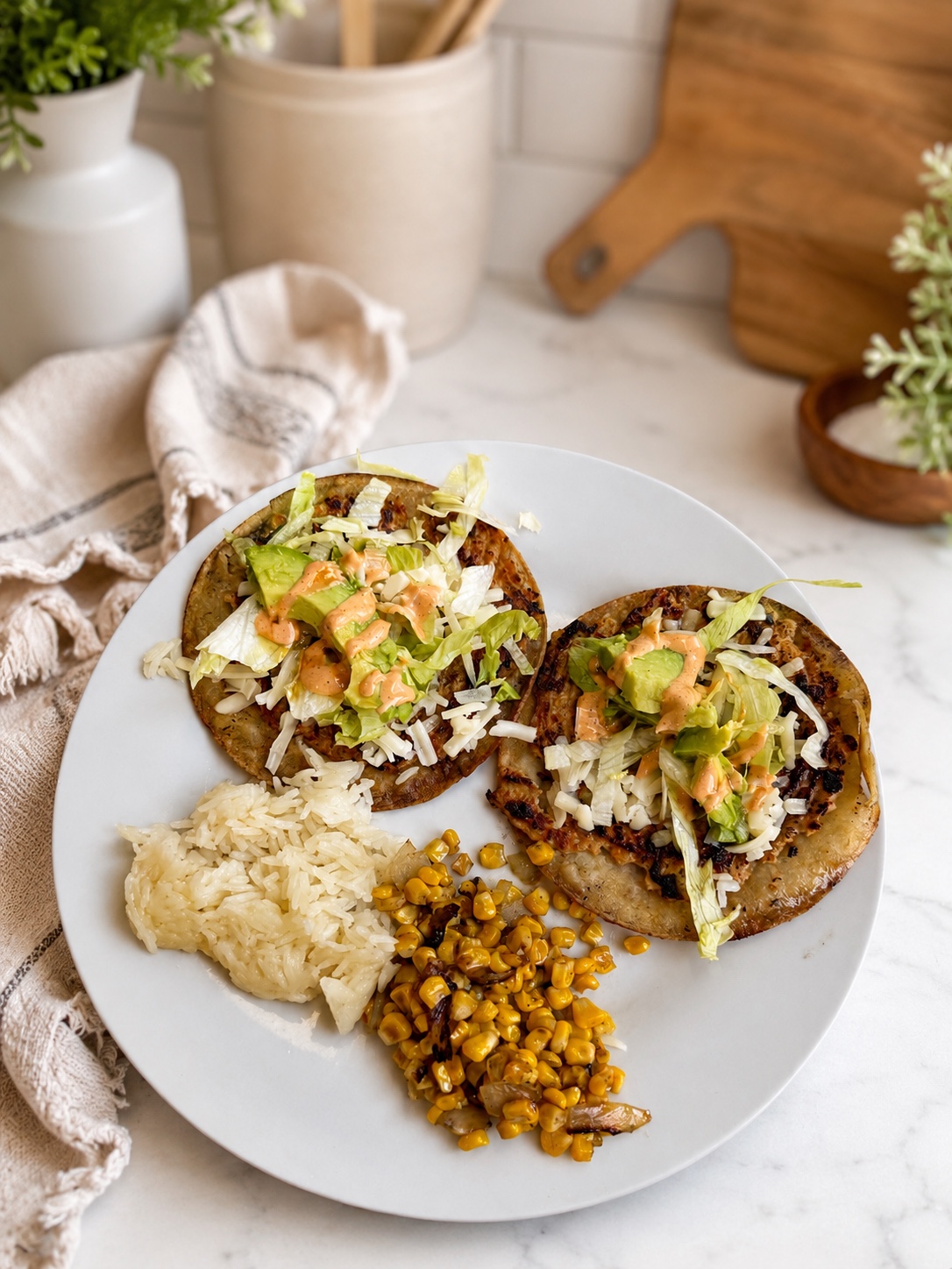 Two loaded tostadas with rice and corn